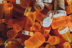 pile of orange prescription bottles