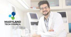 scientist leaning on counter with maryland tech council logo for 2023 icon award nomination